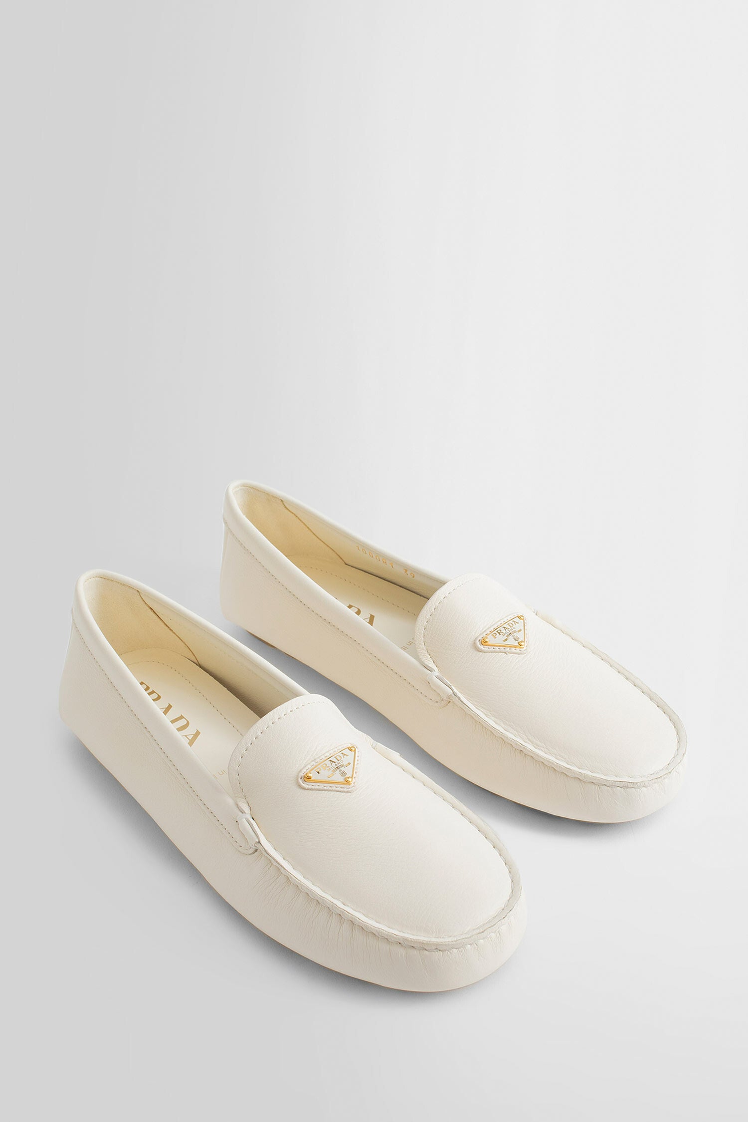 PRADA WOMAN OFF-WHITE LOAFERS & FLATS