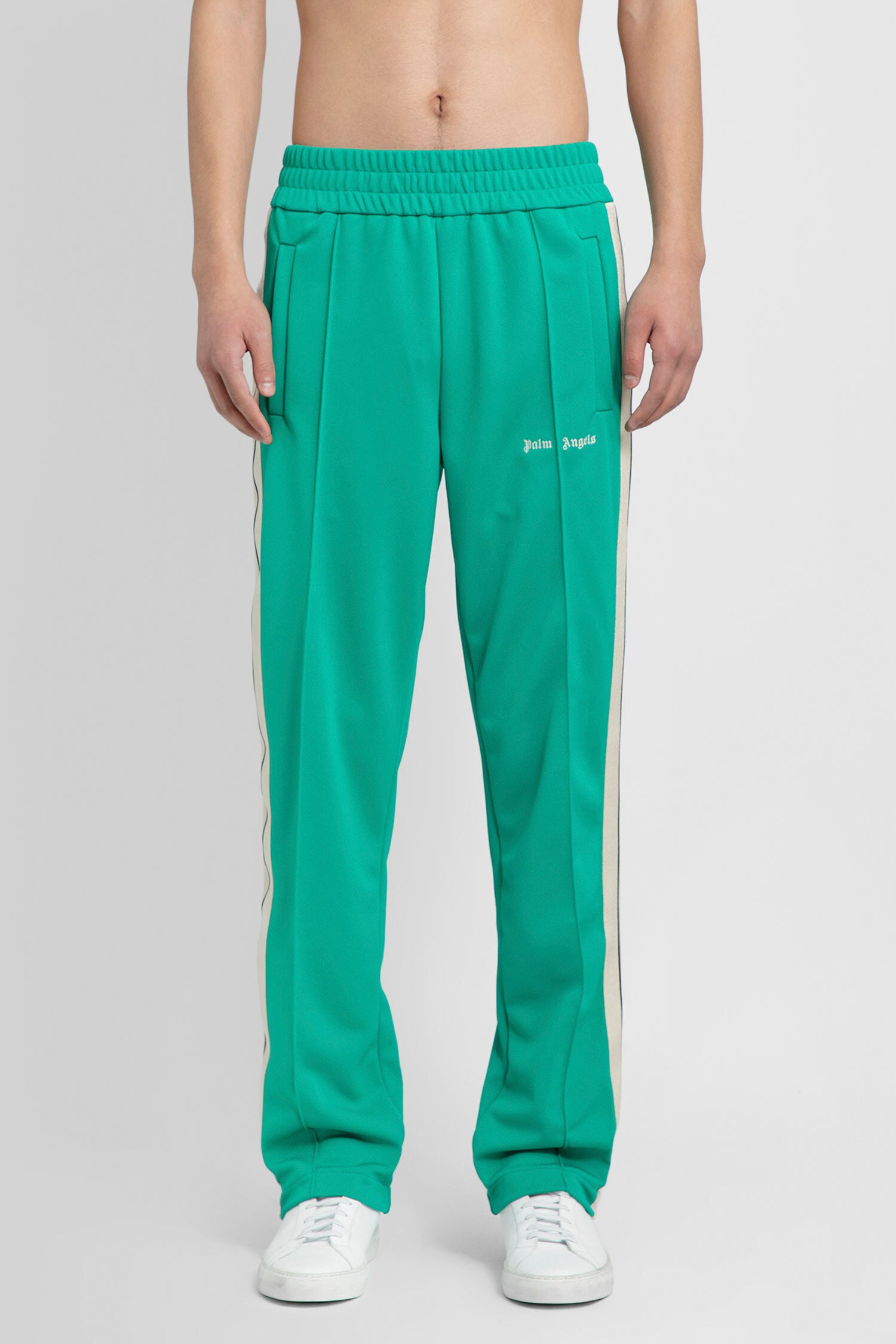 PALM ANGELS MAN GREEN TROUSERS