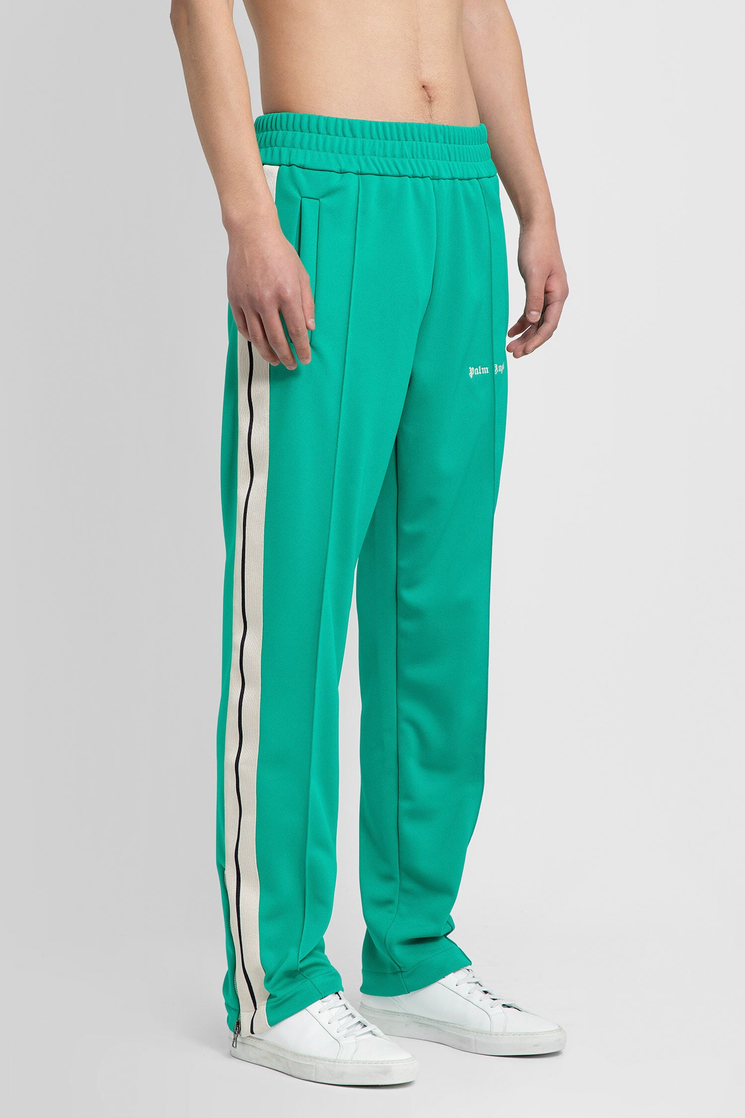 PALM ANGELS MAN GREEN TROUSERS