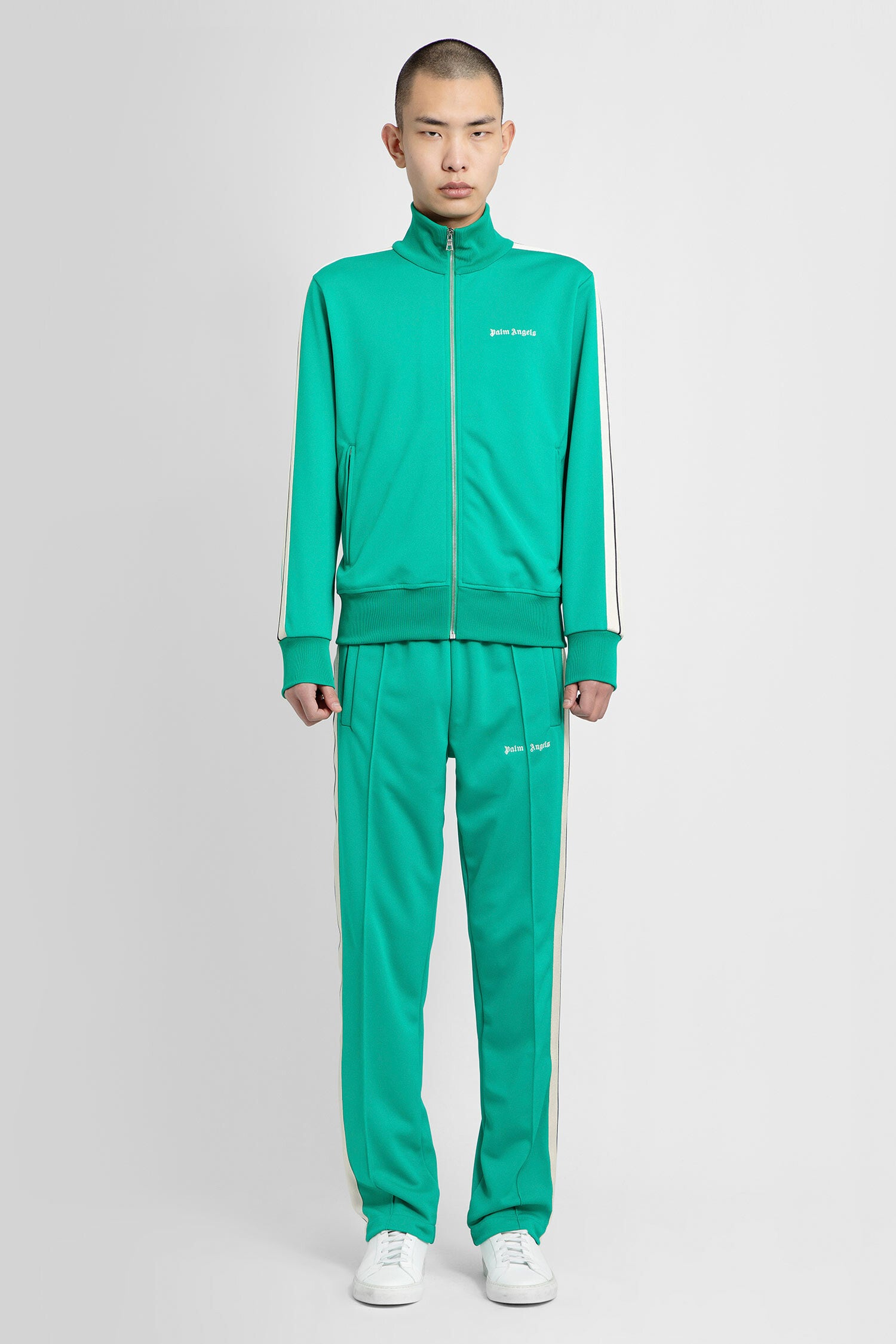 PALM ANGELS MAN GREEN TROUSERS